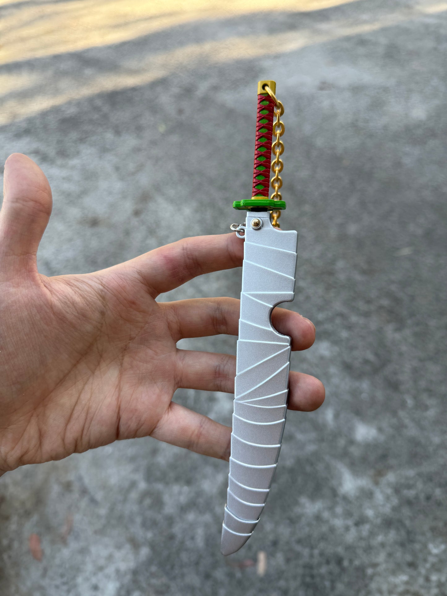 DEMON SLAYER – TENGEN UZUI’S NICHIRIN CLEAVER KEYCHAIN